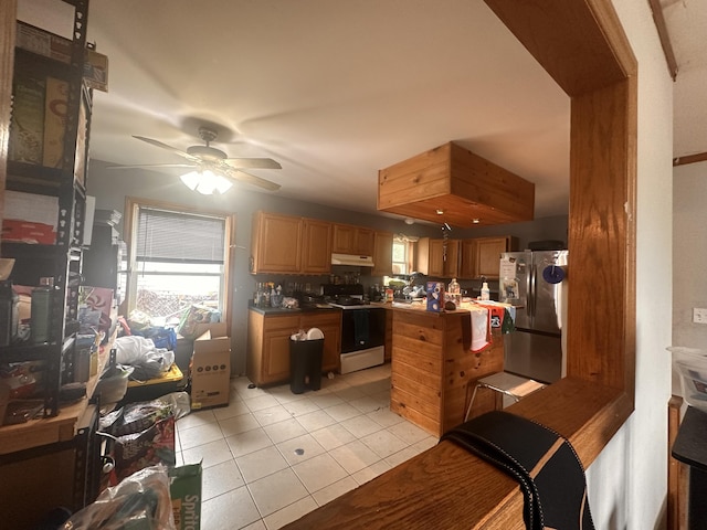 187 Purkis Rd, Buckfield, ME 04220 - kitchen featuring freestanding refrigerator, gas range oven, light tile patterned floors, a ceiling fan, and a kitchen island