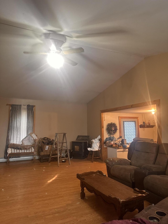 187 Purkis Rd, Buckfield, ME 04220 - living room featuring a wood stove, wood finished floors, a ceiling fan, and vaulted ceiling