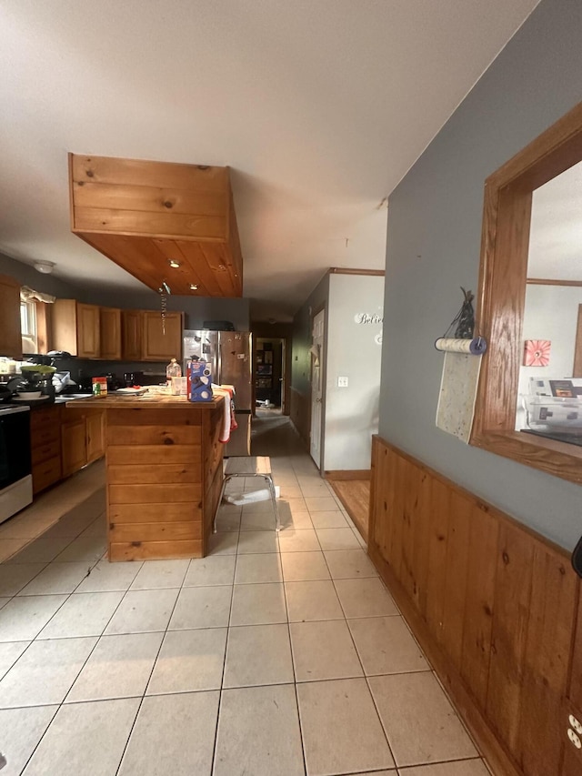 187 Purkis Rd, Buckfield, ME 04220 - kitchen with stainless steel appliances, light tile patterned floors, and brown cabinets