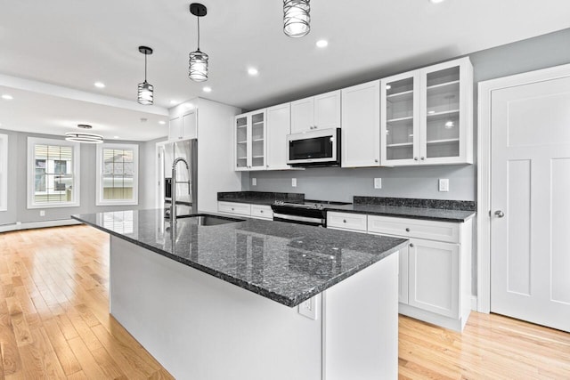 24 Mitton St, Portland, ME 04102 - kitchen featuring appliances with stainless steel finishes, a sink, light wood-type flooring, recessed lighting, and white cabinets