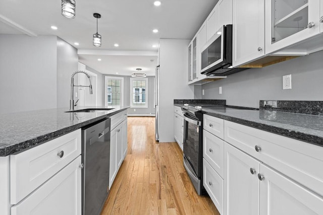 24 Mitton St, Portland, ME 04102 - kitchen featuring stainless steel appliances, a sink, light wood-type flooring, recessed lighting, and white cabinets