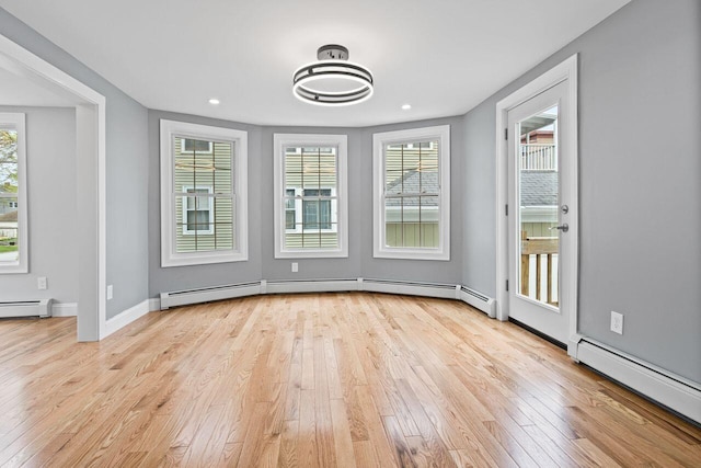 24 Mitton St, Portland, ME 04102 - unfurnished dining area with a baseboard heating unit, wood-type flooring, plenty of natural light, and recessed lighting