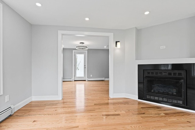 24 Mitton St, Portland, ME 04102 - unfurnished living room featuring baseboard heating, a fireplace, light wood-type flooring, and recessed lighting