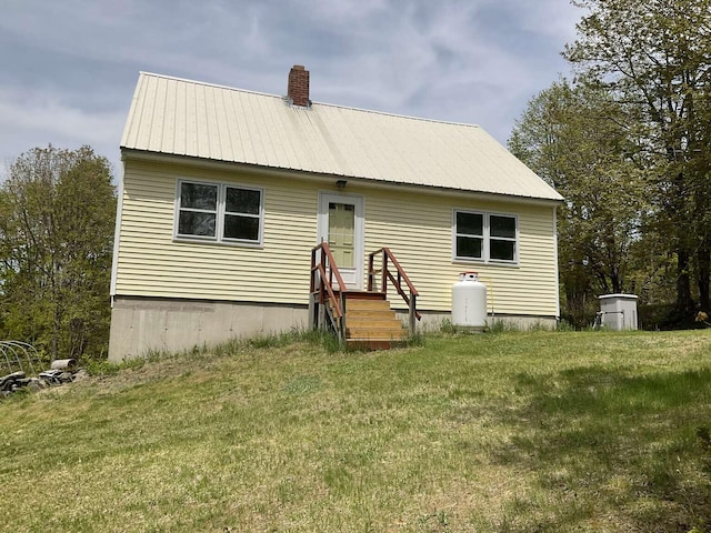 264 Watson Hill Rd, Limerick, ME 04048 - rear view of property featuring entry steps, a lawn, a chimney, and metal roof