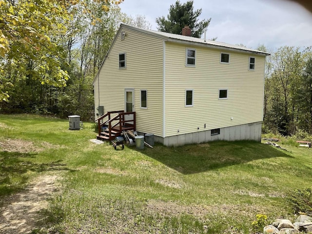 264 Watson Hill Rd, Limerick, ME 04048 - rear view of property featuring a lawn, a chimney, and central air condition unit