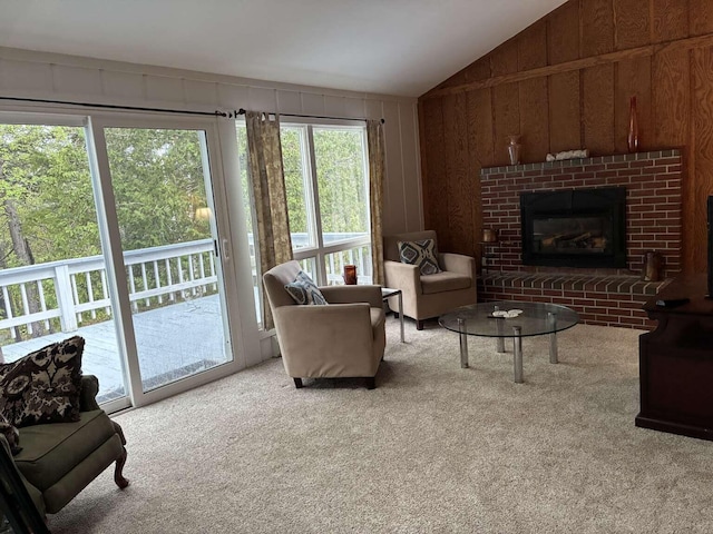 2011 Clark St, Carrabassett Valley, ME 04947 - carpeted living room featuring vaulted ceiling, plenty of natural light, a fireplace, and wood walls