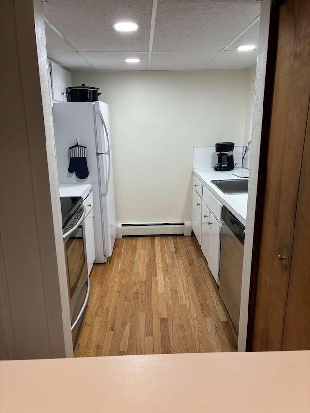 2011 Clark St, Carrabassett Valley, ME 04947 - kitchen featuring range, dishwasher, a baseboard heating unit, white cabinets, and light wood-style floors