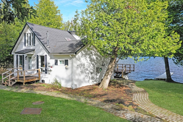 144 Sinclair Rd, Sinclair, ME 04779 - view of front facade with a front yard, a deck with water view, and a shingled roof