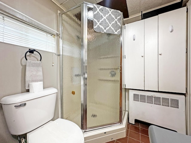144 Sinclair Rd, Sinclair, ME 04779 - bathroom with radiator heating unit, toilet, a shower stall, and tile patterned flooring
