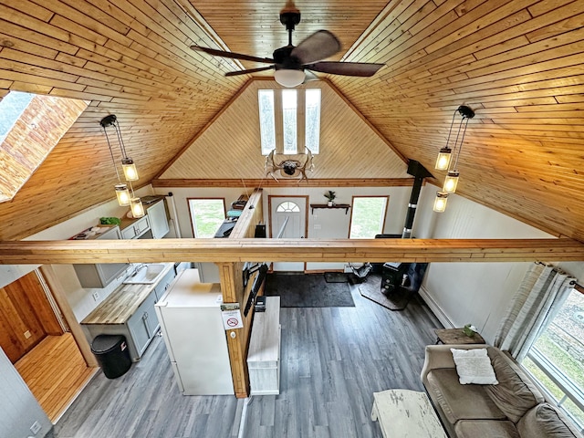 144 Sinclair Rd, Sinclair, ME 04779 - unfurnished living room with wooden ceiling, a ceiling fan, lofted ceiling, and wood finished floors