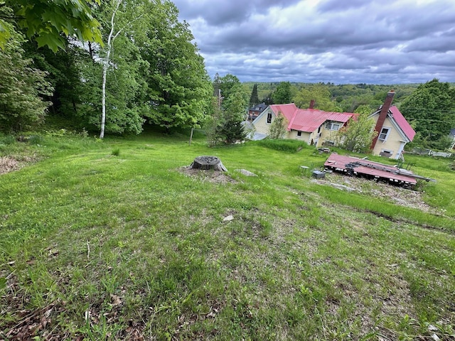 21 High St, Livermore Falls, ME 04254 - view of grassy yard featuring a deck and an outdoor fire pit