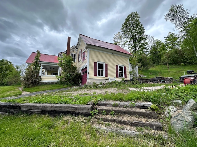 21 High St, Livermore Falls, ME 04254 - view of side of property featuring a chimney and metal roof