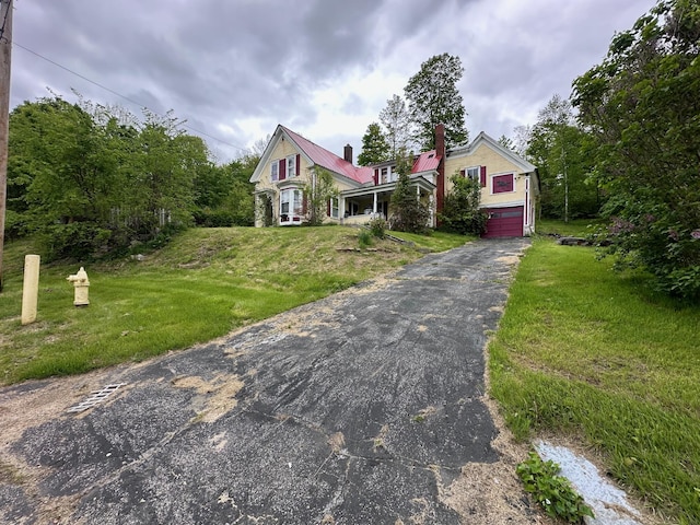 21 High St, Livermore Falls, ME 04254 - victorian home featuring a chimney, a front lawn, a garage, and metal roof