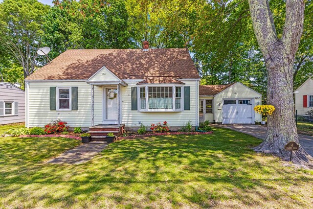 4 Hillside Ave, Biddeford, ME 04005 - view of front of house with a chimney, asphalt driveway, a front yard, and an outbuilding