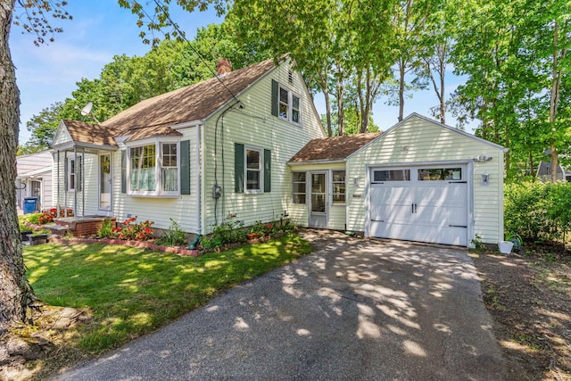 4 Hillside Ave, Biddeford, ME 04005 - view of front of home with asphalt driveway, an attached garage, a chimney, a front yard, and a shingled roof