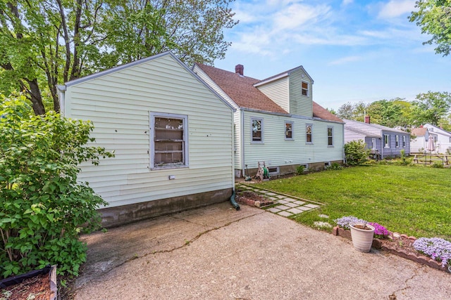 4 Hillside Ave, Biddeford, ME 04005 - rear view of property featuring a lawn, a chimney, a patio, and roof with shingles