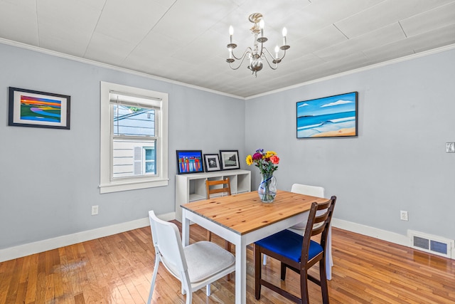 4 Hillside Ave, Biddeford, ME 04005 - dining room with a chandelier, hardwood / wood-style flooring, ornamental molding, and baseboards