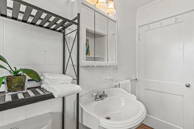 4 Hillside Ave, Biddeford, ME 04005 - half bathroom with tile walls, crown molding, and a sink