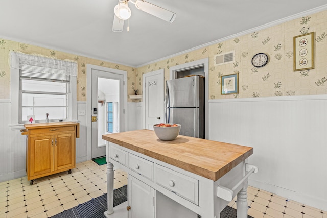 4 Hillside Ave, Biddeford, ME 04005 - kitchen featuring freestanding refrigerator, wooden counters, wainscoting, light flooring, and ceiling fan