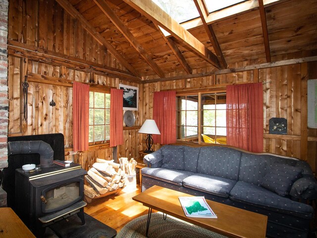 44 Cove Ln, Damariscotta, ME 04543 - living room featuring wooden walls, wood ceiling, a wood stove, wood finished floors, and a skylight