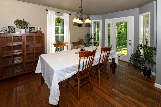 93 Maple St, Fryeburg, ME 04037 - dining space with a chandelier, dark wood-style floors, and baseboards