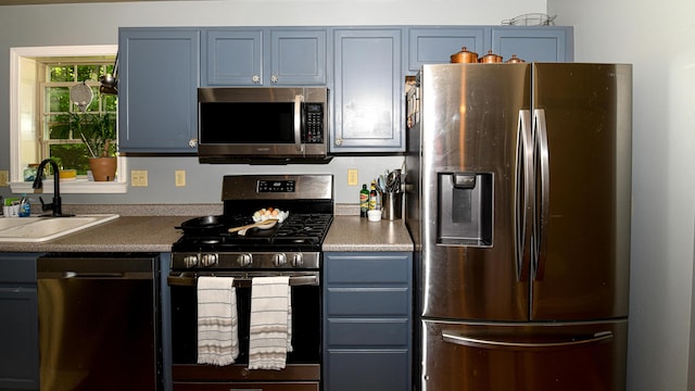 93 Maple St, Fryeburg, ME 04037 - kitchen with stainless steel appliances, a sink, and blue cabinets