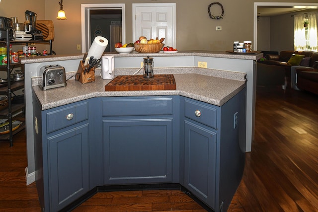 93 Maple St, Fryeburg, ME 04037 - kitchen with blue cabinets, open floor plan, dark wood-type flooring, and pendant lighting