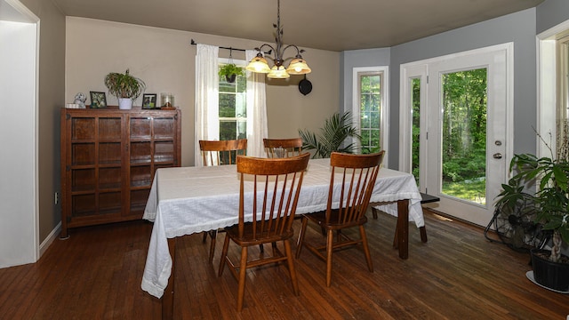 93 Maple St, Fryeburg, ME 04037 - dining area with a chandelier, healthy amount of natural light, dark wood-type flooring, and baseboards