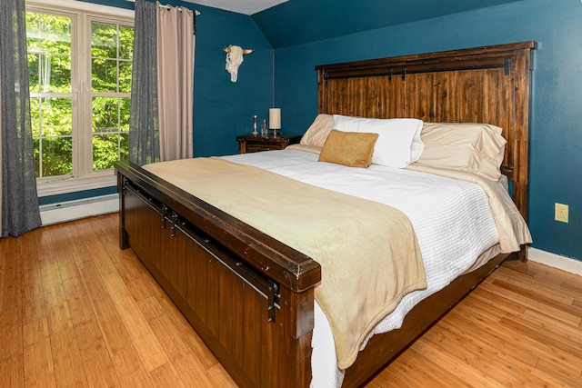 93 Maple St, Fryeburg, ME 04037 - bedroom with baseboard heating, light wood-style flooring, baseboards, and lofted ceiling