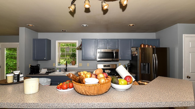 93 Maple St, Fryeburg, ME 04037 - kitchen with stainless steel appliances, a sink, light countertops, recessed lighting, and blue cabinetry