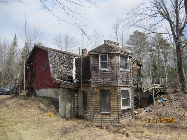 40 Cookson Dr, Kenduskeag, ME 04450 - view of side of home with a gambrel roof, a chimney, and a shingled roof