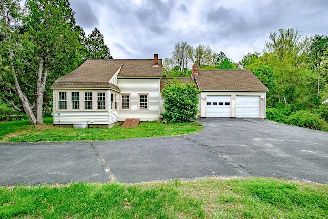 41 Bolton Hill Rd, Augusta, ME 04330 - view of front facade with a chimney and a detached garage