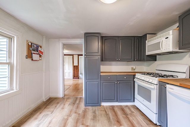 41 Bolton Hill Rd, Augusta, ME 04330 - kitchen featuring white appliances, gray cabinetry, light wood-type flooring, healthy amount of natural light, and a wainscoted wall