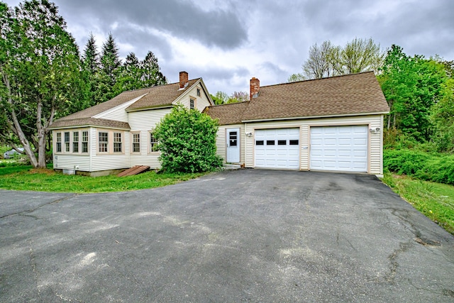 41 Bolton Hill Rd, Augusta, ME 04330 - view of front facade with a chimney, driveway, an attached garage, and a shingled roof