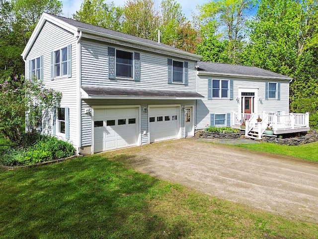 25 Parmenter Ter, China, ME 04358 - raised ranch with driveway, a garage, a front yard, a deck, and view of wooded area