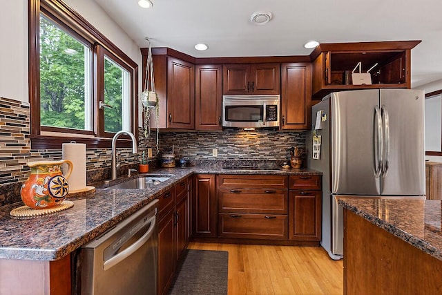 25 Parmenter Ter, China, ME 04358 - kitchen with stainless steel appliances, a sink, light wood finished floors, dark stone countertops, and recessed lighting