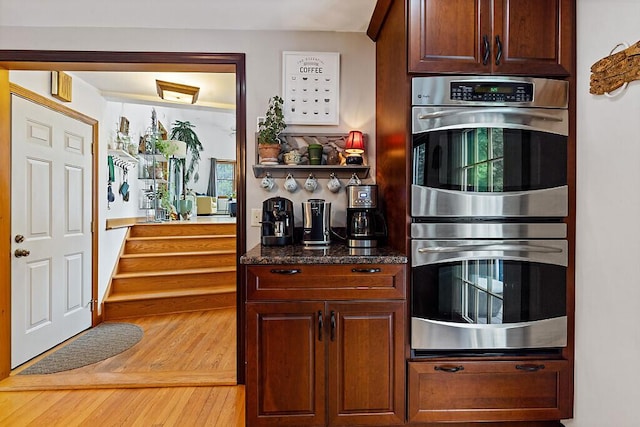 25 Parmenter Ter, China, ME 04358 - kitchen with double oven, wood finished floors, and dark stone counters