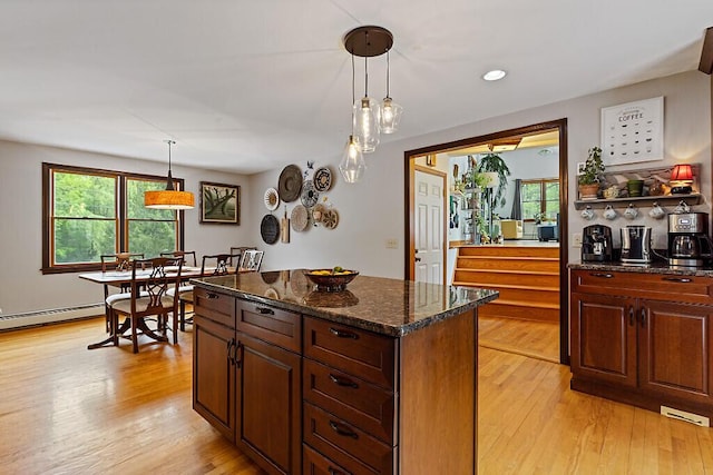 25 Parmenter Ter, China, ME 04358 - kitchen featuring light wood-style flooring, pendant lighting, dark stone countertops, and recessed lighting