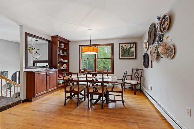 25 Parmenter Ter, China, ME 04358 - dining space with a baseboard radiator, light wood-style floors, and baseboards