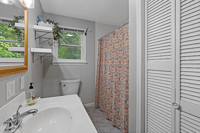 25 Parmenter Ter, China, ME 04358 - bathroom featuring a sink, toilet, a closet, tile patterned flooring, and a shower with curtain