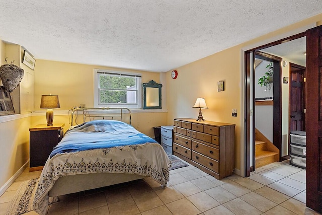 25 Parmenter Ter, China, ME 04358 - bedroom with a textured ceiling, baseboards, and light tile patterned floors