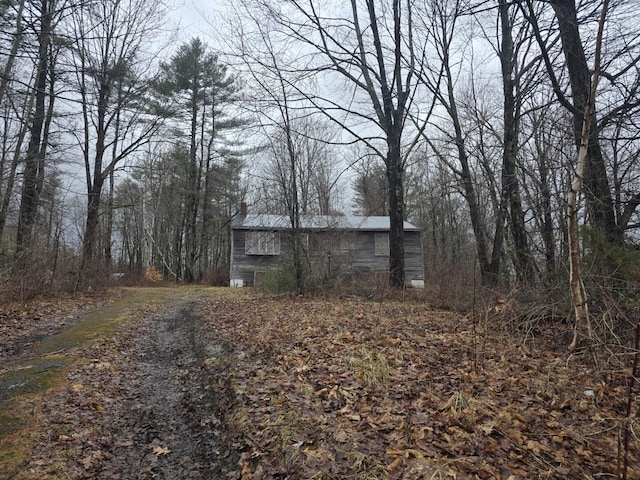 12 Middle Jam Rd, Gorham, ME 04038 - view of side of home with a chimney, a barn, and an outbuilding