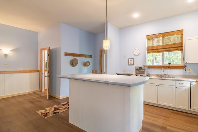 57 Sunset Rd, Dedham, ME 04429 - kitchen featuring a sink, light wood-type flooring, white cabinetry, light countertops, and recessed lighting
