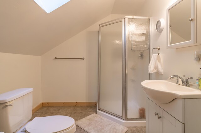 57 Sunset Rd, Dedham, ME 04429 - bathroom with lofted ceiling, toilet, a stall shower, vanity, and baseboards