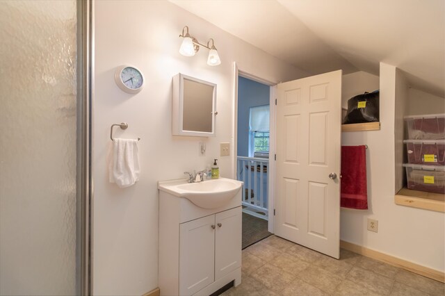 57 Sunset Rd, Dedham, ME 04429 - bathroom with vaulted ceiling and vanity