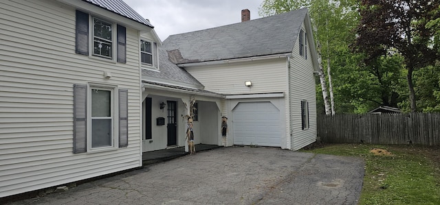 18 Pine St, Skowhegan, ME 04976 - view of front of home featuring roof with shingles, driveway, a chimney, and an attached garage