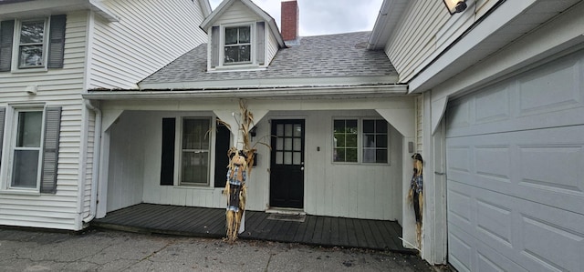18 Pine St, Skowhegan, ME 04976 - entrance to property with roof with shingles, a chimney, a porch, and an attached garage