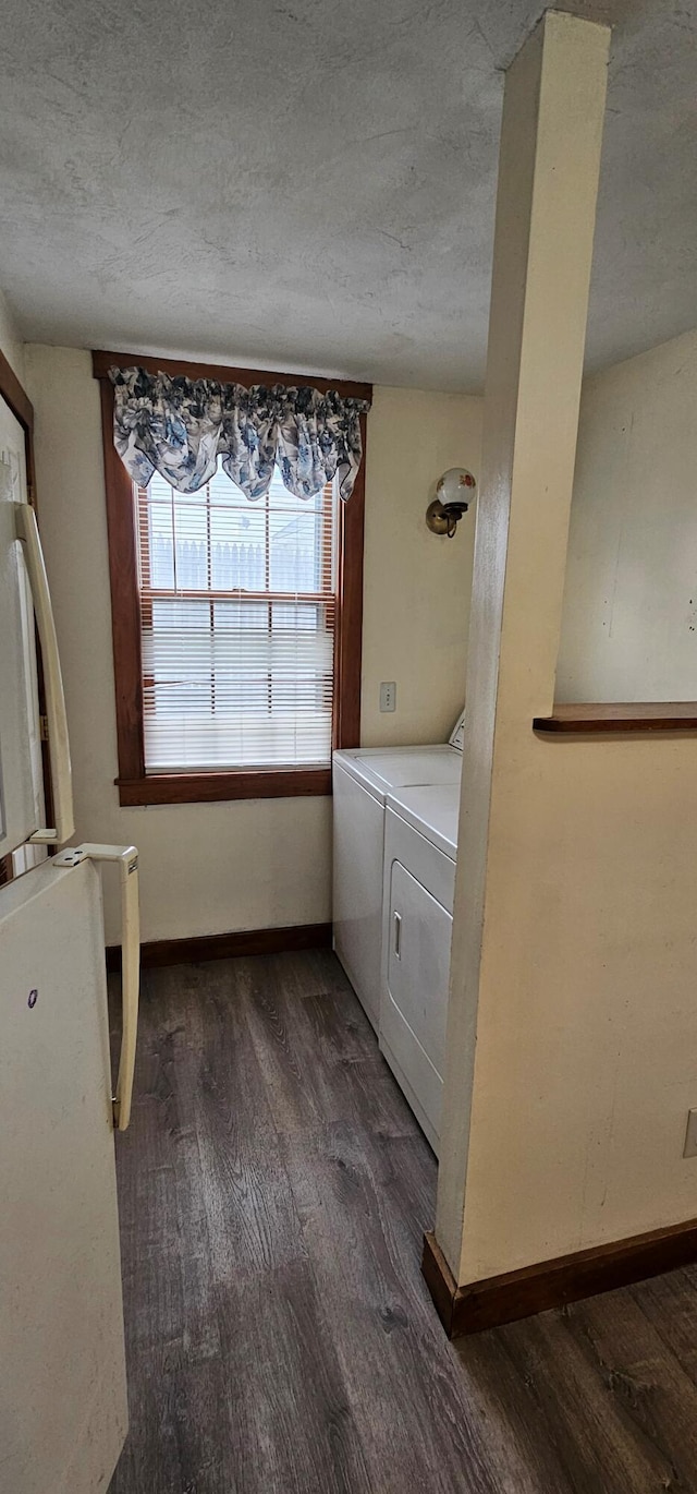 18 Pine St, Skowhegan, ME 04976 - laundry area featuring washing machine and clothes dryer, dark wood-style floors, a textured ceiling, and baseboards