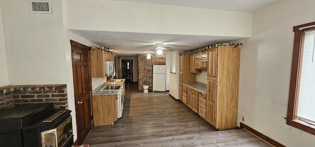 18 Pine St, Skowhegan, ME 04976 - kitchen with freestanding refrigerator, stainless steel microwave, dark wood finished floors, baseboards, and a ceiling fan