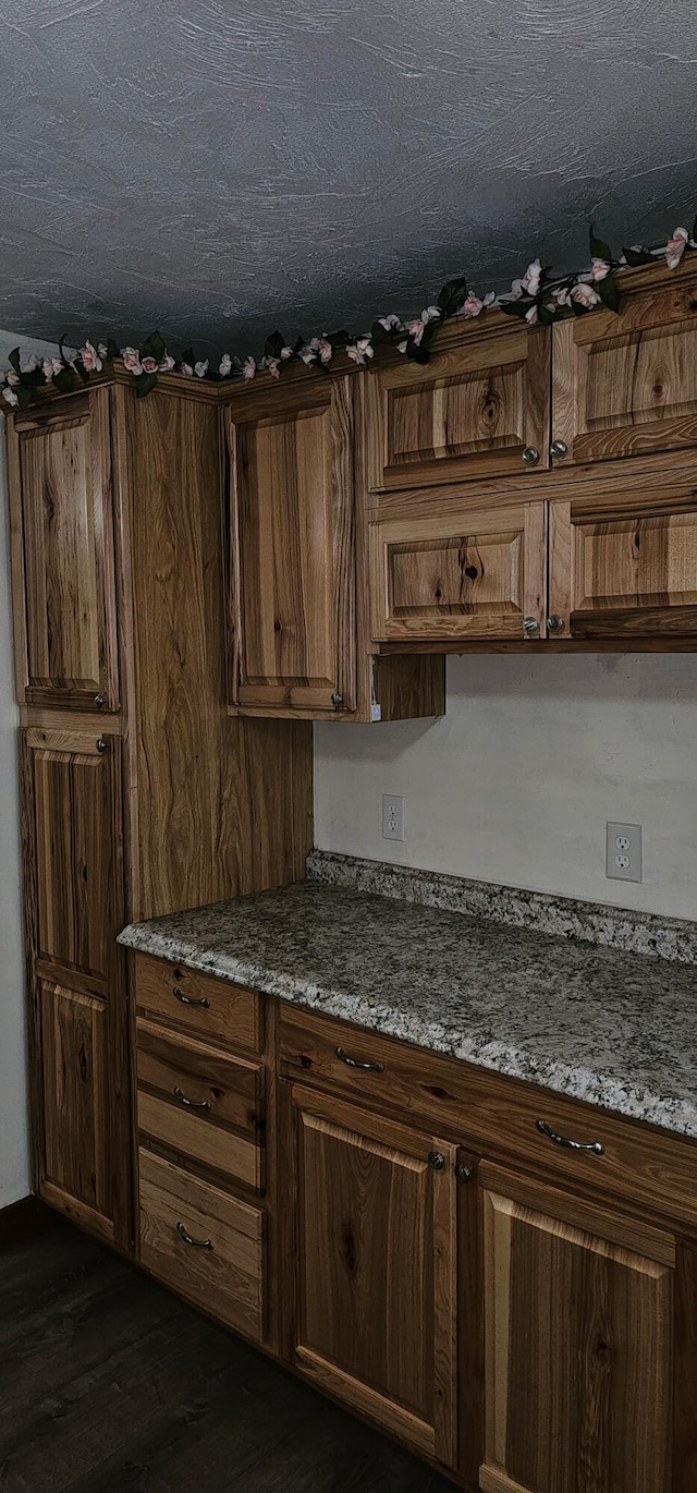 18 Pine St, Skowhegan, ME 04976 - kitchen featuring dark wood-style floors and brown cabinetry